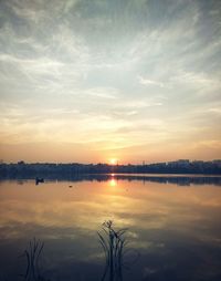 View of calm lake at sunset