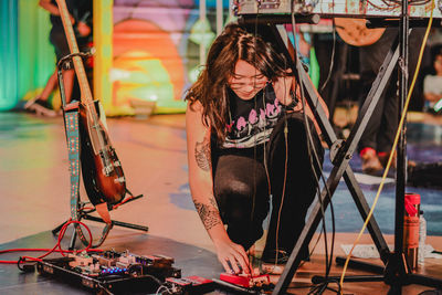 Young woman sitting at music concert