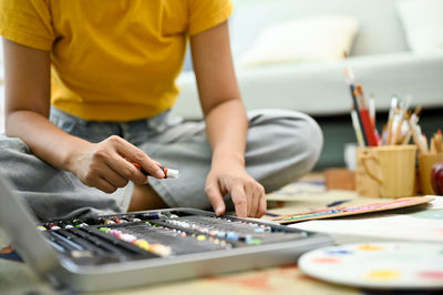 Midsection of man working at table