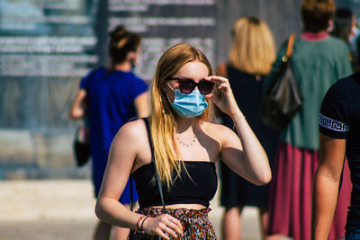 Young woman wearing sunglasses standing outdoors