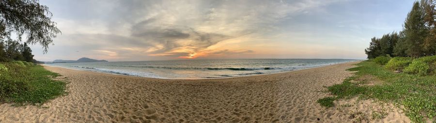 Scenic view of beach against sky during sunset