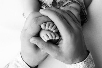Close-up of mother and baby hands