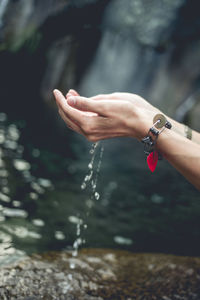 Cropped hands of woman with water