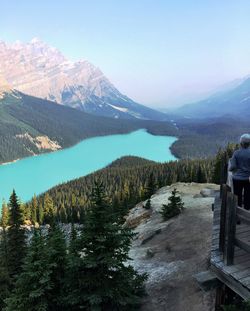 Scenic view of lake by mountains against sky