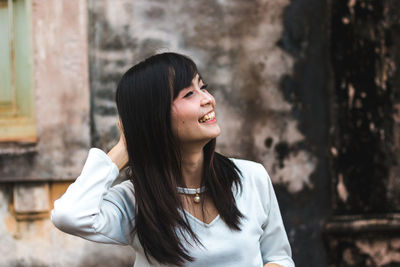 Cheerful young woman looking away