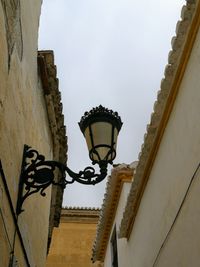 Low angle view of street light mounted on wall