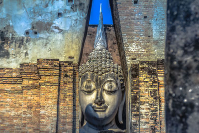 Close-up of statue against building