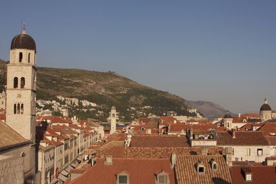High angle view of buildings in town against clear sky