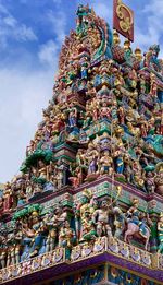 Low angle view of statues on building against sky