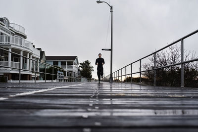 Athlete jogging on boardwalk