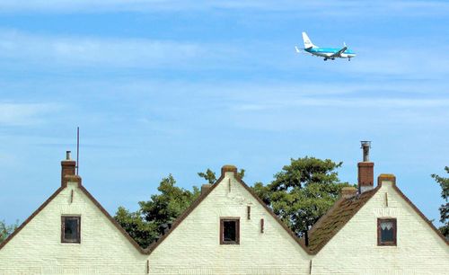 Airplane above houses