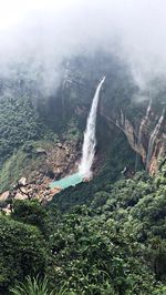 Scenic view of waterfall against sky