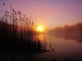 Scenic view of lake against sky during sunset