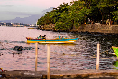 Man sitting in boat on sea