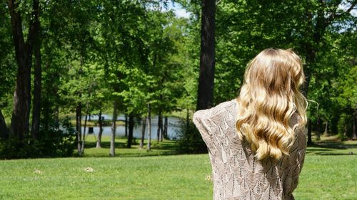 Rear view of woman looking at trees