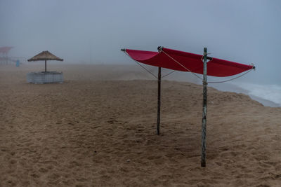 Lifeguard hut on beach against sky