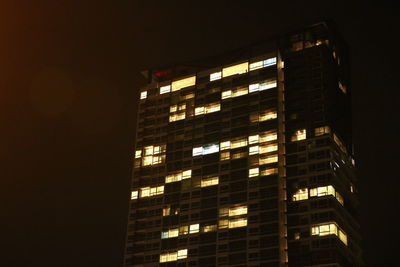 Low angle view of office building at night