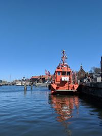 View of buildings in city against clear blue sky