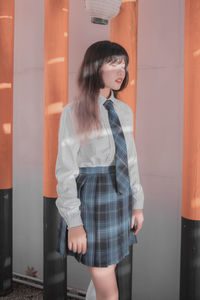 Portrait of young woman standing in train