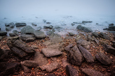 High angle view of rocks on beach against sky