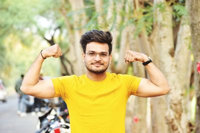 Portrait of young man standing in park