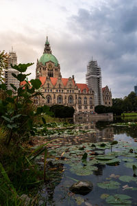 Buildings at waterfront against sky