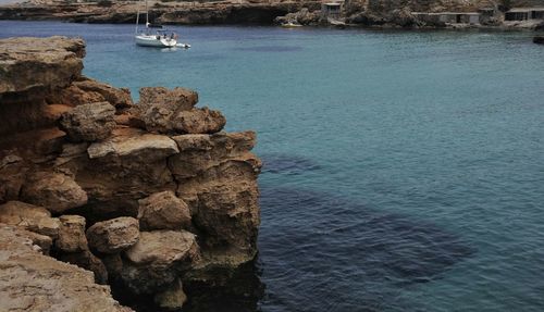Boats sailing in sea against sky