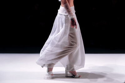 Rear view of woman standing on table