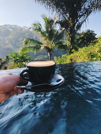 Person holding cup of coffee