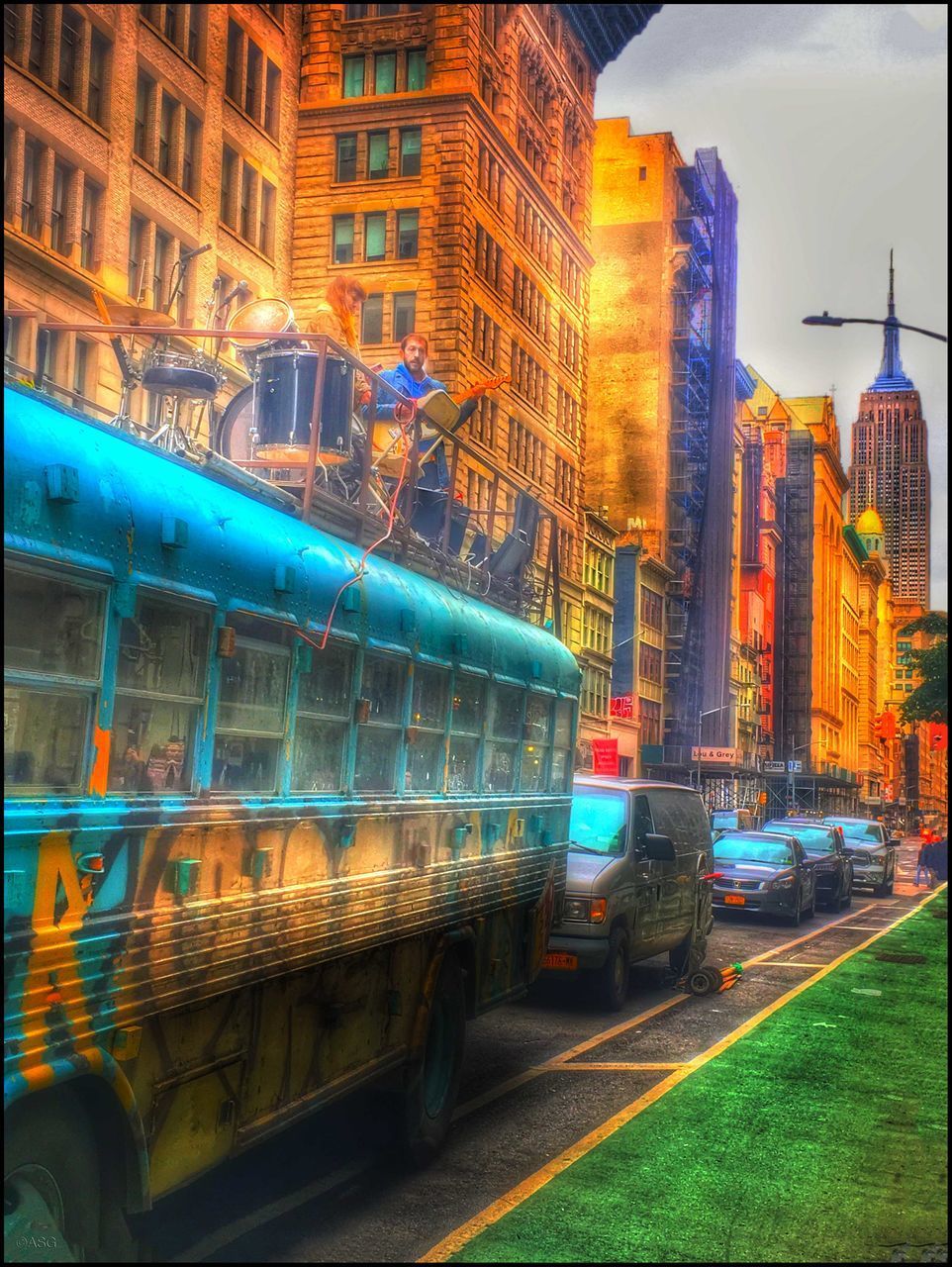 ILLUMINATED BUILDINGS BY STREET IN CITY DURING RAINY SEASON