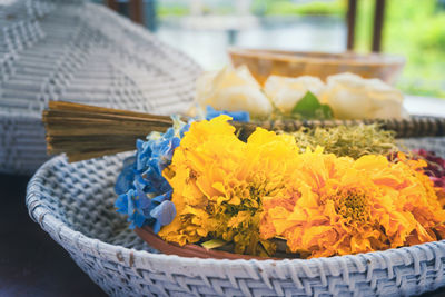 Close-up of yellow flowers in basket