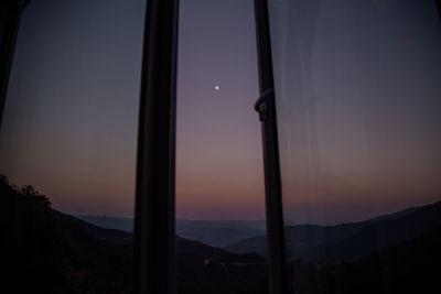 Scenic view of silhouette mountains against sky at sunset