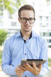 Portrait of young man using mobile phone