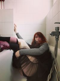 Woman with arms raised at home