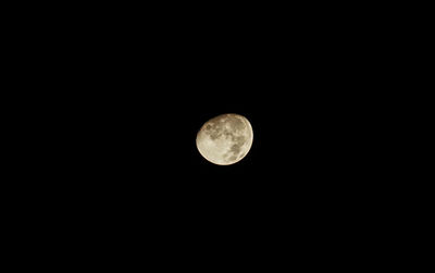 Low angle view of full moon against sky at night