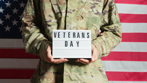 Usa soldier holding a veterans day panel on memorial day