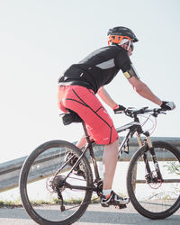 Low angle view of person riding bicycle