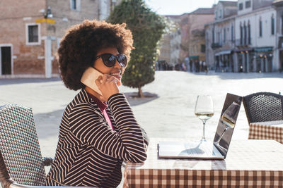 Young woman on table in city