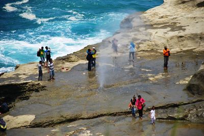 People standing on beach by sea