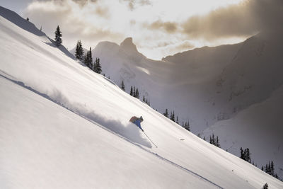 Man skiing on snowcapped mountain