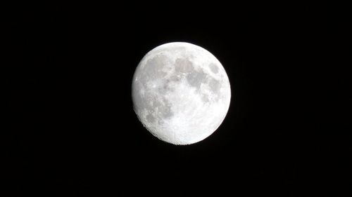 Low angle view of moon against sky at night