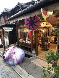 Multi colored lanterns in market against buildings in city