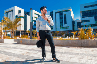 Full length of young man standing against wall