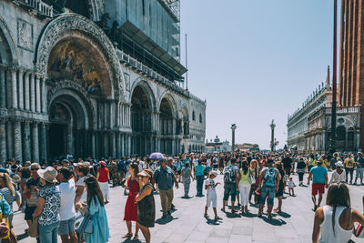 People at st marks cathedral against sky