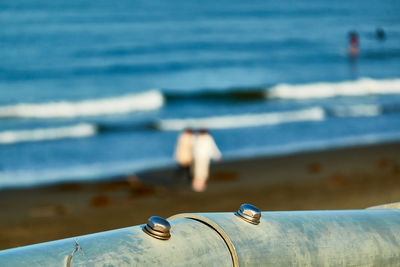 Close-up of pipes on sea shore