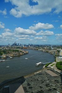 High angle view of townscape by sea against sky