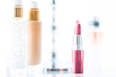 Close-up of beauty products against white background