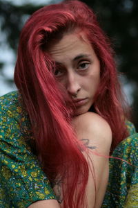 Portrait of young woman with a sad look and red hair 