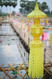 Close-up of yellow lantern hanging in temple