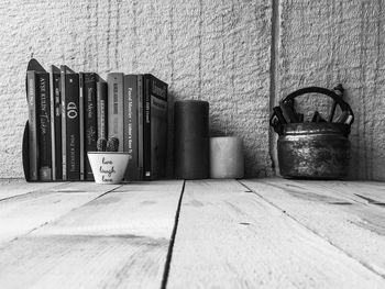 Close-up of old objects on table against wall